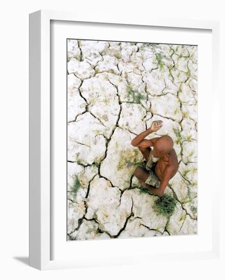 An Indian Farmer Sits in His Dried up Field in Hanumanganj, India-null-Framed Photographic Print