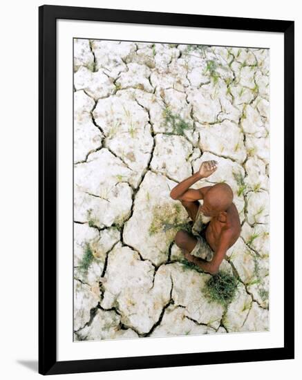 An Indian Farmer Sits in His Dried up Field in Hanumanganj, India-null-Framed Photographic Print