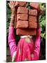An Indian Woman Construction Worker Stacks Bricks on Her Head-null-Mounted Photographic Print
