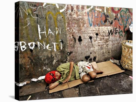 An Indonesian Boy Wearing a Spiderman Mask Sleeps on a Piece of Cardboard-Ed Wray-Stretched Canvas