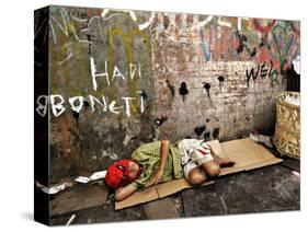 An Indonesian Boy Wearing a Spiderman Mask Sleeps on a Piece of Cardboard-Ed Wray-Stretched Canvas