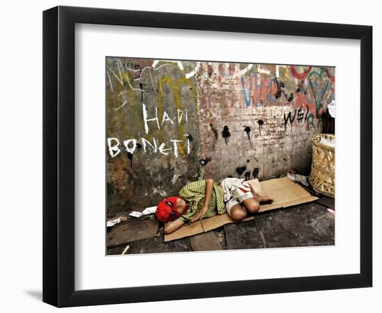 An Indonesian Boy Wearing a Spiderman Mask Sleeps on a Piece of Cardboard-Ed Wray-Framed Photographic Print