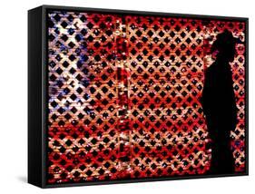 An Man Wearing a Cowboy Hat Walks Past an American Flag Light Display-Brandi Simons-Framed Stretched Canvas