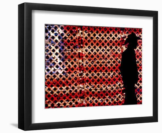 An Man Wearing a Cowboy Hat Walks Past an American Flag Light Display-Brandi Simons-Framed Photographic Print