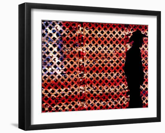 An Man Wearing a Cowboy Hat Walks Past an American Flag Light Display-Brandi Simons-Framed Photographic Print