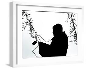 An Man Wires Christmas Lights-null-Framed Photographic Print