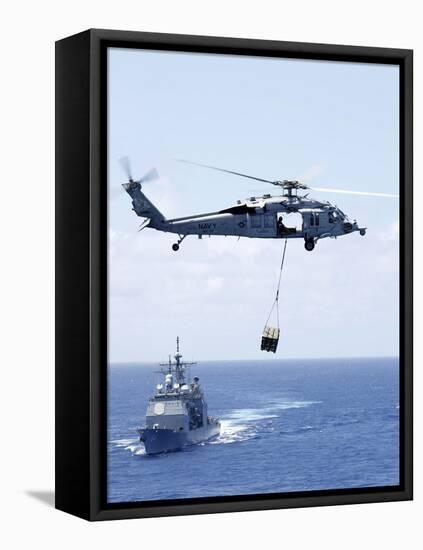 An Mh-60S Sea Hawk Helicopter Flying in Front of USS Gettysburg-null-Framed Stretched Canvas