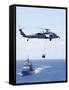 An Mh-60S Sea Hawk Helicopter Flying in Front of USS Gettysburg-null-Framed Stretched Canvas