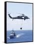 An Mh-60S Sea Hawk Helicopter Flying in Front of USS Gettysburg-null-Framed Stretched Canvas