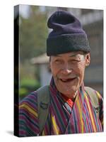 An Old Man at Trashigang Wearing the Traditional Gho Robe of All Bhutanese Men-Nigel Pavitt-Stretched Canvas