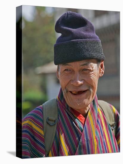 An Old Man at Trashigang Wearing the Traditional Gho Robe of All Bhutanese Men-Nigel Pavitt-Stretched Canvas