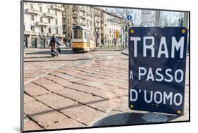 An old sign in Italian that says Trams go to Duomo, with a traditional Milanese tram in the backgro-Alexandre Rotenberg-Mounted Photographic Print