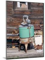 An old washing machine and old rusty stove on the porch of a building in ghost town.-Julie Eggers-Mounted Photographic Print