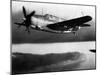 An Sb2c (Curtiss Helldiver) Flies over a Japanese Convoy Burning in Cam Ranh Bay after Attack by Pl-null-Mounted Photographic Print