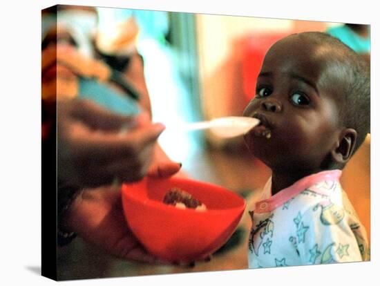 An Unidentified Baby is Fed at a Home for Hiv/Aids and Abandoned Children-null-Stretched Canvas