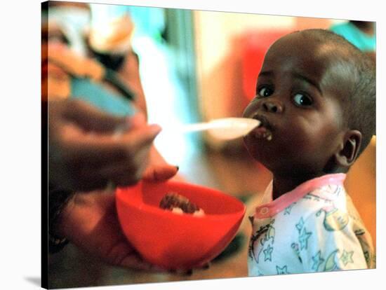 An Unidentified Baby is Fed at a Home for Hiv/Aids and Abandoned Children-null-Stretched Canvas