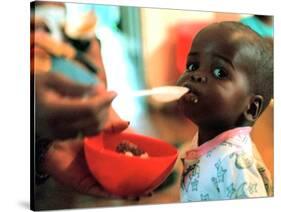 An Unidentified Baby is Fed at a Home for Hiv/Aids and Abandoned Children-null-Stretched Canvas