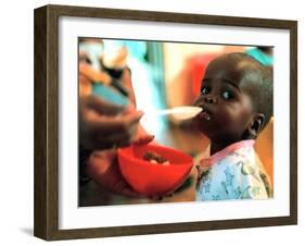 An Unidentified Baby is Fed at a Home for Hiv/Aids and Abandoned Children-null-Framed Premium Photographic Print