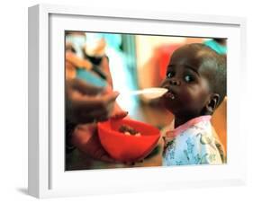 An Unidentified Baby is Fed at a Home for Hiv/Aids and Abandoned Children-null-Framed Premium Photographic Print