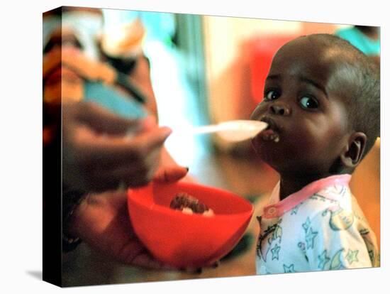 An Unidentified Baby is Fed at a Home for Hiv/Aids and Abandoned Children-null-Stretched Canvas