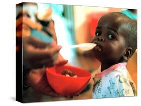 An Unidentified Baby is Fed at a Home for Hiv/Aids and Abandoned Children-null-Stretched Canvas