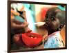 An Unidentified Baby is Fed at a Home for Hiv/Aids and Abandoned Children-null-Framed Photographic Print