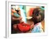 An Unidentified Baby is Fed at a Home for Hiv/Aids and Abandoned Children-null-Framed Photographic Print