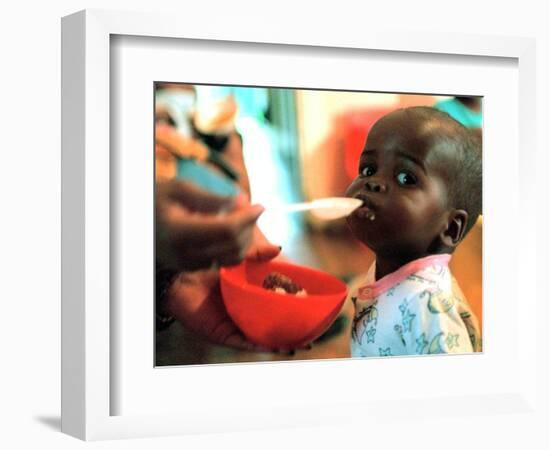 An Unidentified Baby is Fed at a Home for Hiv/Aids and Abandoned Children-null-Framed Photographic Print