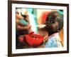 An Unidentified Baby is Fed at a Home for Hiv/Aids and Abandoned Children-null-Framed Photographic Print