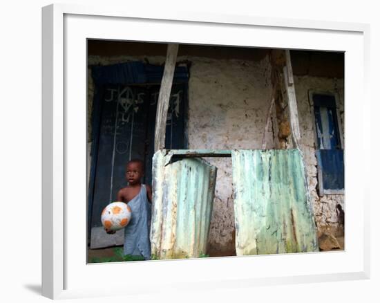 An Unidentified Boy Stands Outside a House-null-Framed Photographic Print