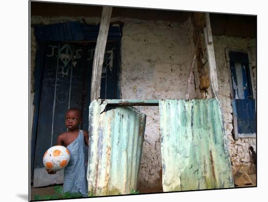 An Unidentified Boy Stands Outside a House-null-Mounted Photographic Print