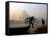 An Unidentified Cyclist Gets Down with His Cycle against the Backdrop of the Taj Mahal-null-Framed Stretched Canvas