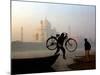 An Unidentified Cyclist Gets Down with His Cycle against the Backdrop of the Taj Mahal-null-Mounted Photographic Print