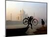 An Unidentified Cyclist Gets Down with His Cycle against the Backdrop of the Taj Mahal-null-Mounted Photographic Print