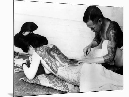 An Unidentified Japanese Tattoo Artist Works on a Woman's Backside-null-Mounted Photographic Print