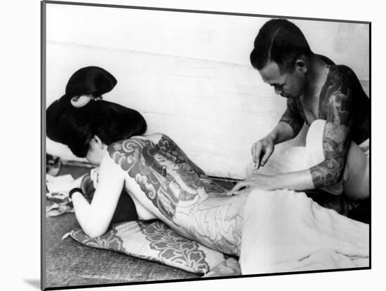 An Unidentified Japanese Tattoo Artist Works on a Woman's Backside-null-Mounted Photographic Print