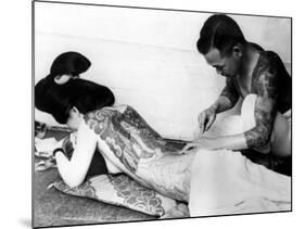 An Unidentified Japanese Tattoo Artist Works on a Woman's Backside-null-Mounted Photographic Print