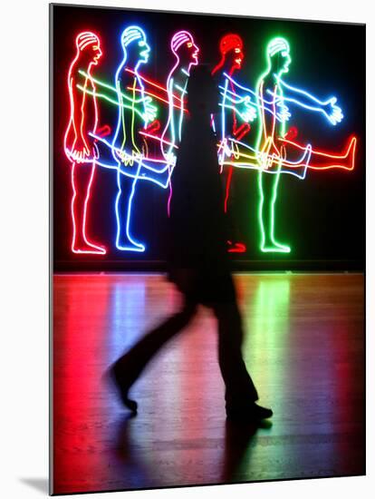 An Unidentified Visitor Passes an Art Installation by Bruce Naumann-null-Mounted Photographic Print