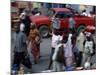 An Water Vendor Walks in the Streets of Port-Au-Prince, Haiti-null-Mounted Photographic Print