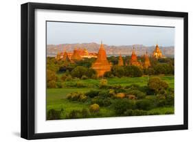 Ancient temple and pagoda rising out of the jungle at sunrise, Bagan, Mandalay Region, Myanmar-Keren Su-Framed Photographic Print