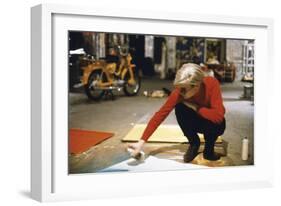 Andy with Spray Paint and Moped, The Factory, NYC, circa 1965-Nat Finkelstein-Framed Art Print