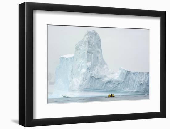 Antarctica. Charlotte Bay. Zodiac Dwarfed by a Giant Towering Iceberg-Inger Hogstrom-Framed Photographic Print