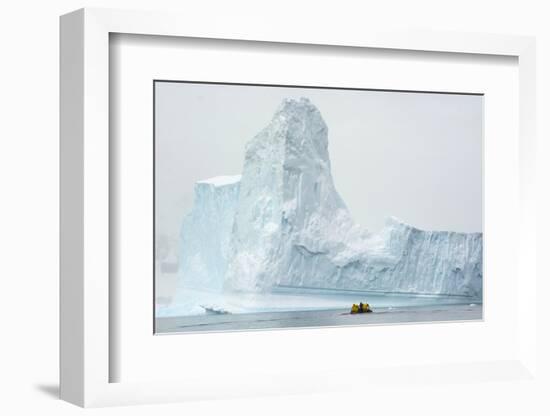 Antarctica. Charlotte Bay. Zodiac Dwarfed by a Giant Towering Iceberg-Inger Hogstrom-Framed Photographic Print