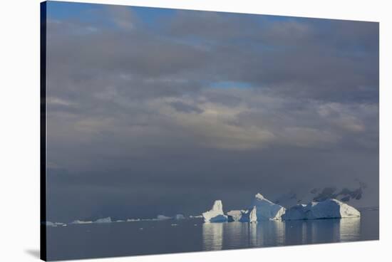 Antarctica. Gerlache Strait. Iceberg and Cloudy Skies-Inger Hogstrom-Stretched Canvas