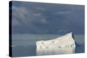 Antarctica. Gerlache Strait. Iceberg and Cloudy Skies-Inger Hogstrom-Stretched Canvas