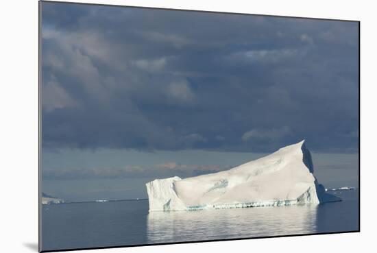 Antarctica. Gerlache Strait. Iceberg and Cloudy Skies-Inger Hogstrom-Mounted Photographic Print