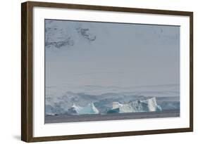 Antarctica. Gerlache Strait. Iceberg with Glacier in the Background-Inger Hogstrom-Framed Photographic Print