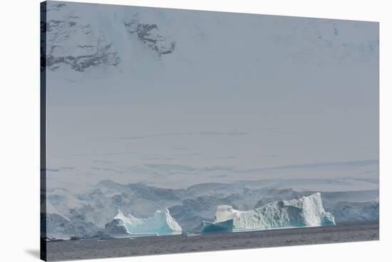 Antarctica. Gerlache Strait. Iceberg with Glacier in the Background-Inger Hogstrom-Stretched Canvas