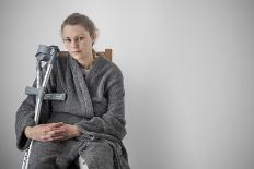 Woman Watching TV with Crutches-Anthony West-Photographic Print