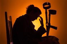 Woman Watching TV with Crutches-Anthony West-Photographic Print